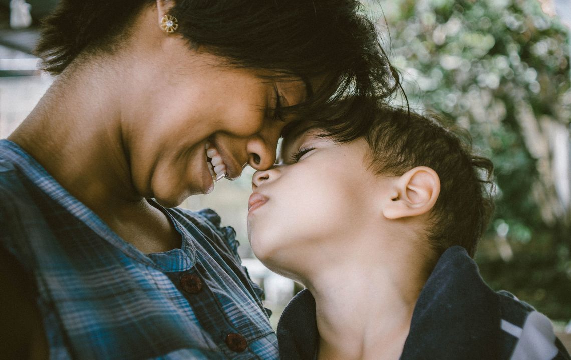 a mother and child cuddle