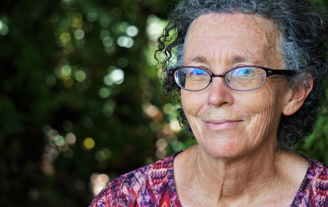 An older woman looks into the camera