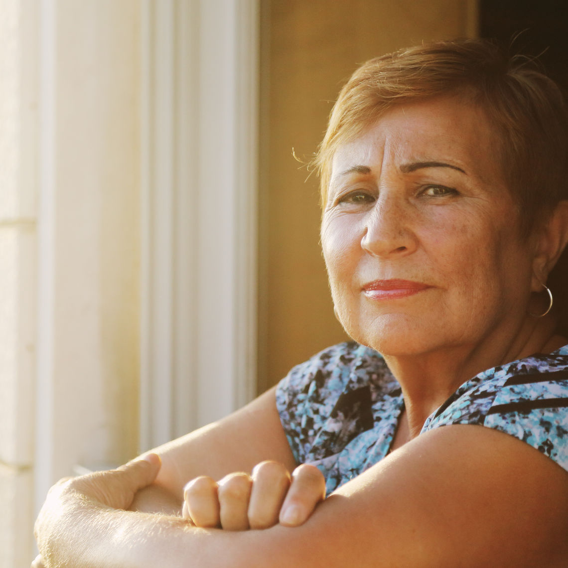 Portrait of senior woman looking from the balcony