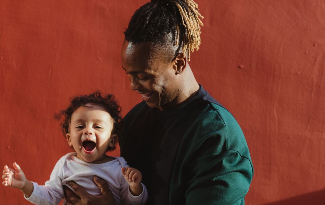 A father holds his baby son.