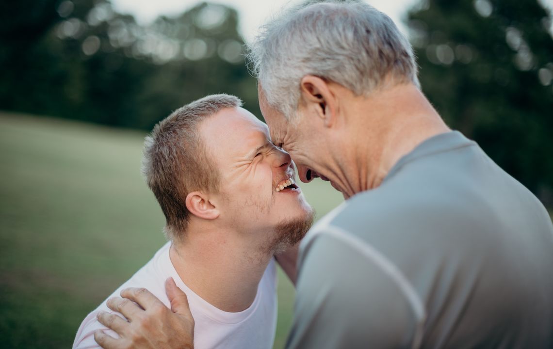 A father hugs his son, who has Down's syndrome.