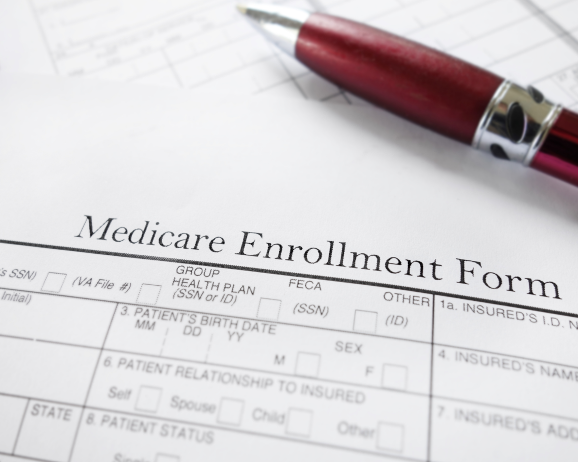 A Medicare enrollment form sits on a table.