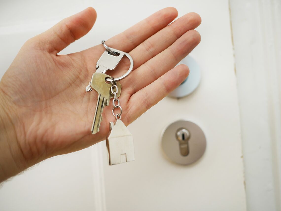 A person holds the keys to their home