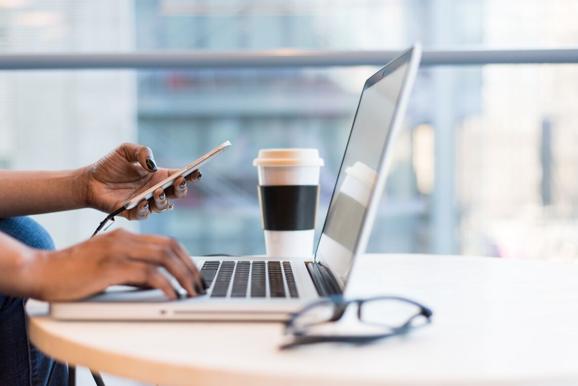 A woman sits in front of her laptop at work.