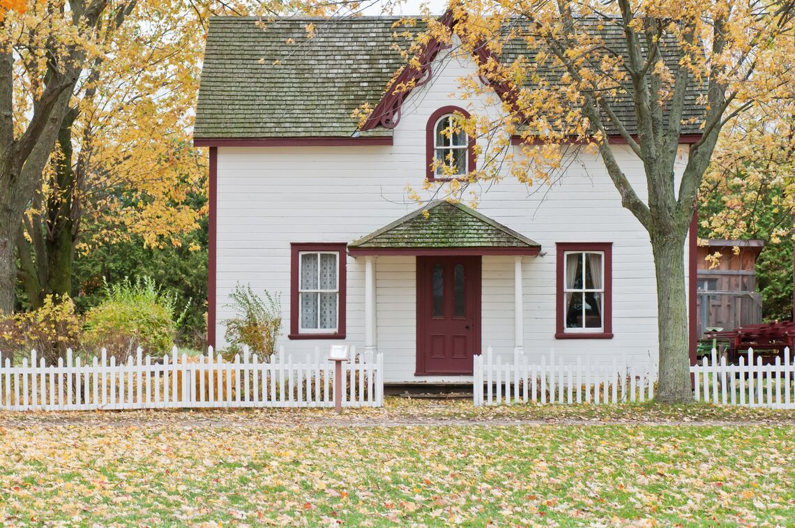 A red and white house in fall